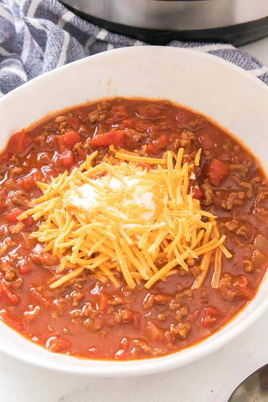 bowl of keto chili topped with sour cream and cheese