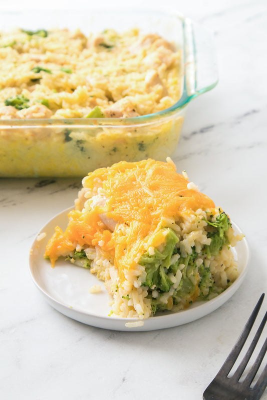 Chicken Broccoli and Rice Casserole topped with cheese on white plate