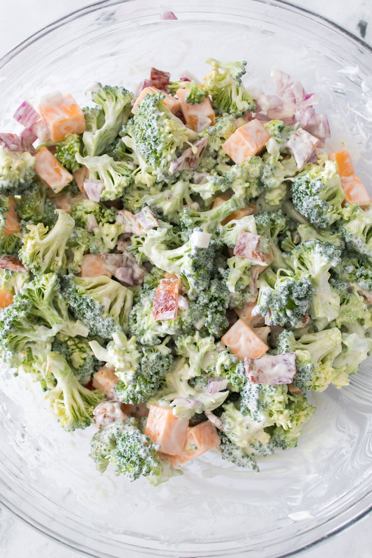close up shot to show all ingredients in broccoli salad recipe in glass bowl