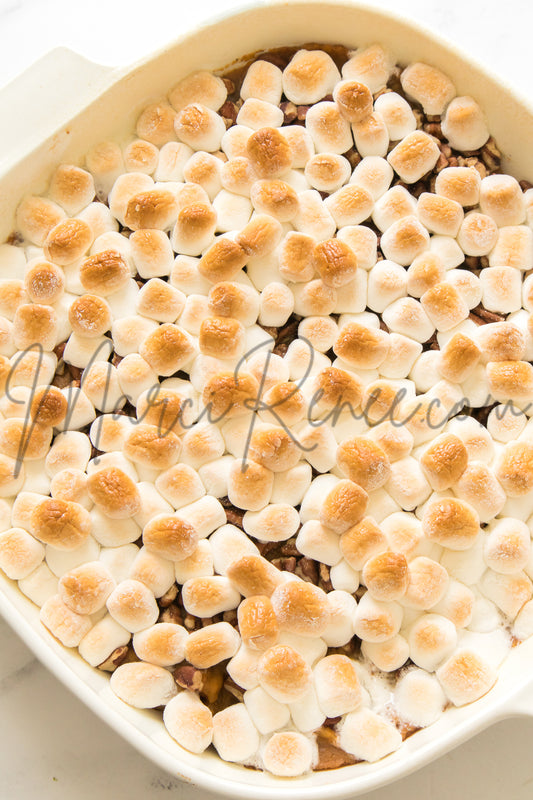 Sweet potato casserole in baking dish topped with toasted marshmallows