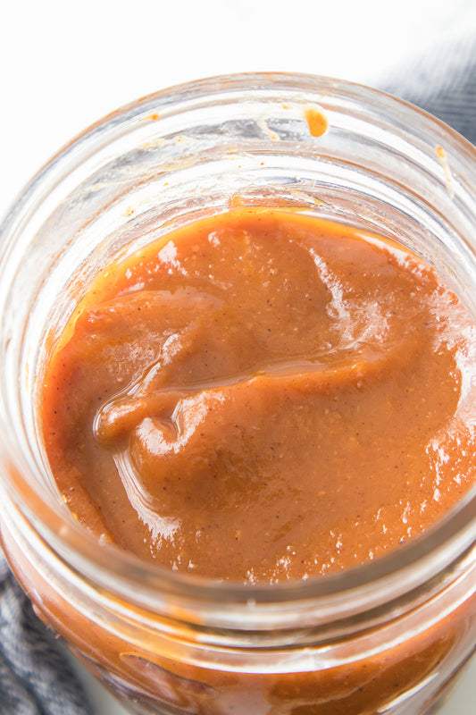 vertical close up shot of homemade pumpkin butter in mason jar