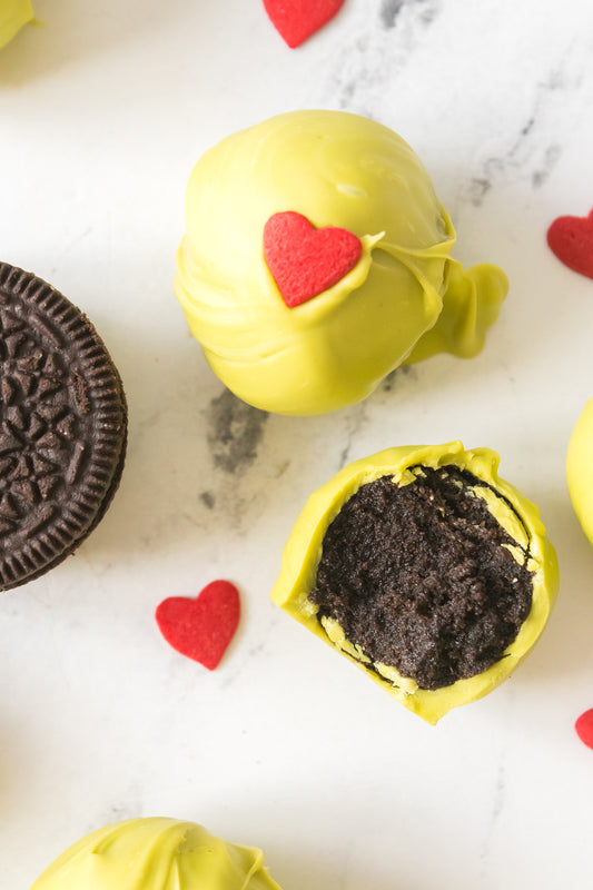 Grinch Oreo Truffle with one split open to see the fudginess inside