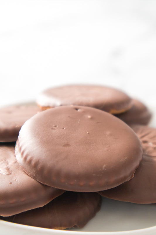 homemade thin mint cookies stacked on top of one another on white plate