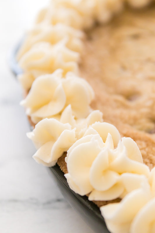 close up shot of white icing piped onto cookie cake