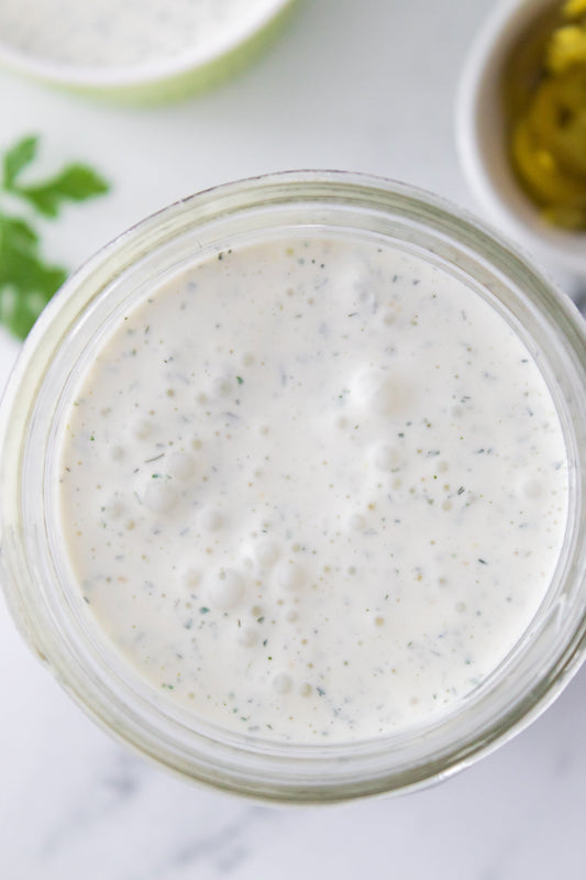 close up shot of jalapeno ranch dressing in mason jar