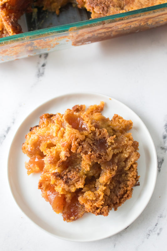 overhead shot of apple dump cake on white plate