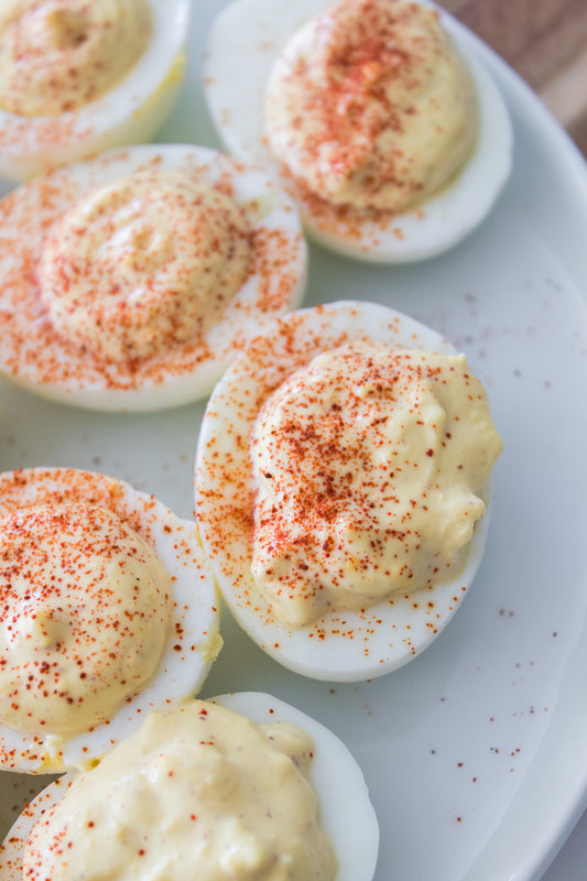 close up overhead shot of deviled eggs on white plate